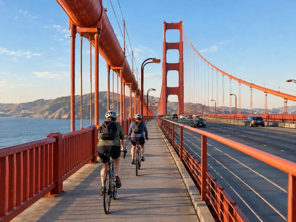Cyclists riding the sidewalk of the Golden Gate Bridge